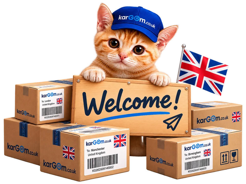 A ginger kitten in a Kargom cap holding a Welcome sign, sitting among Kargom parcels